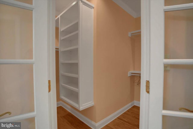 spacious closet with hardwood / wood-style flooring