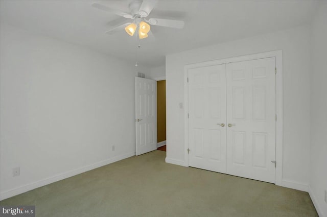 unfurnished bedroom featuring a closet, carpet, and ceiling fan