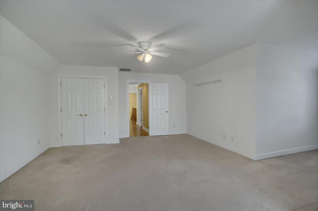 bonus room featuring vaulted ceiling, light carpet, and ceiling fan