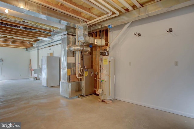 basement with heating unit, water heater, and white refrigerator