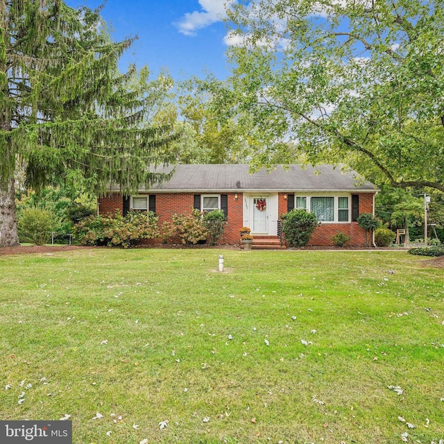 ranch-style house with brick siding and a front lawn