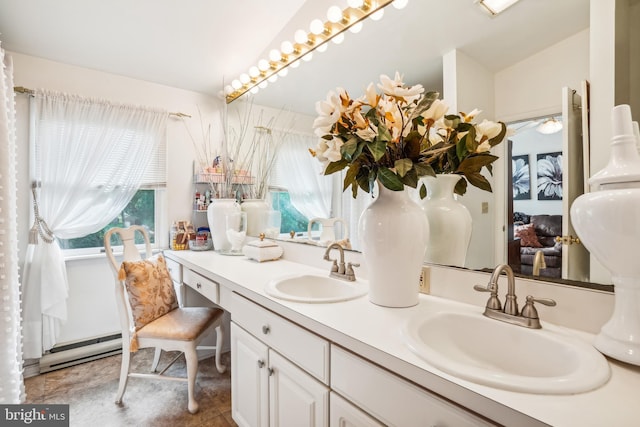 bathroom with vanity, lofted ceiling, and a baseboard radiator