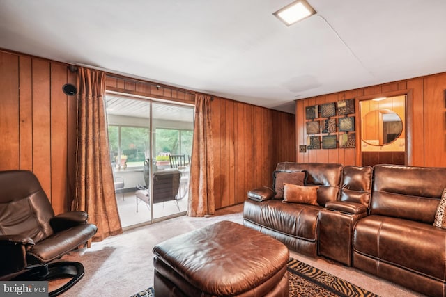 carpeted living room with wood walls