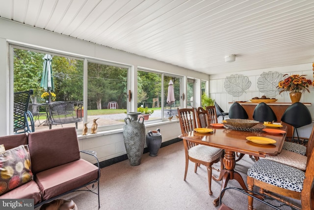 sunroom / solarium featuring speckled floor