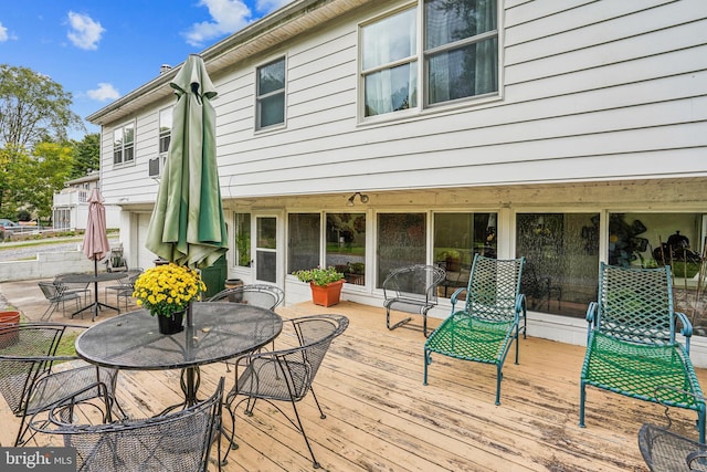 deck with outdoor dining area