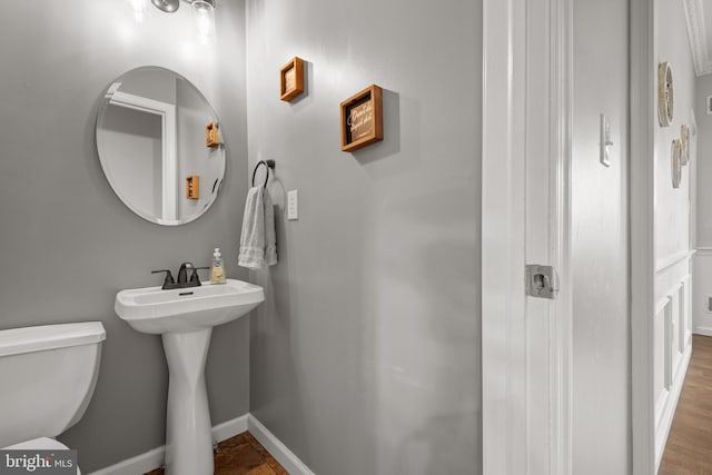 bathroom with wood-type flooring and toilet