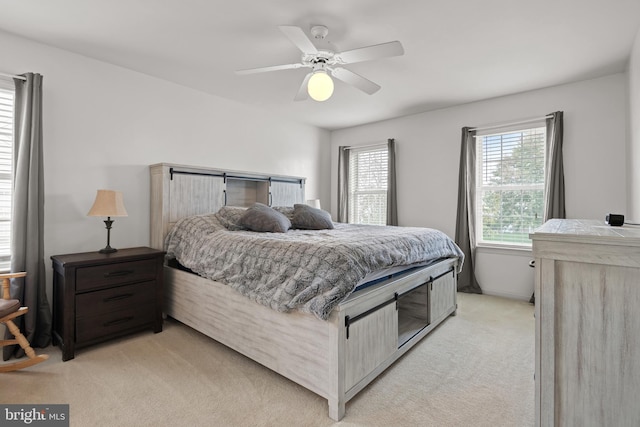 bedroom featuring light colored carpet and ceiling fan