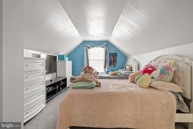 bedroom with lofted ceiling and carpet floors