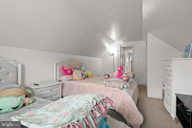 carpeted bedroom with vaulted ceiling