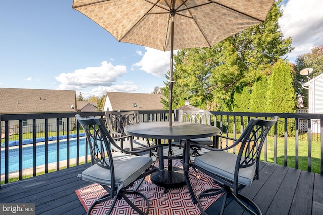 wooden terrace with a fenced in pool