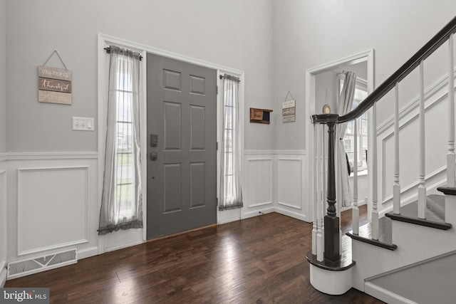 foyer entrance with dark wood-type flooring