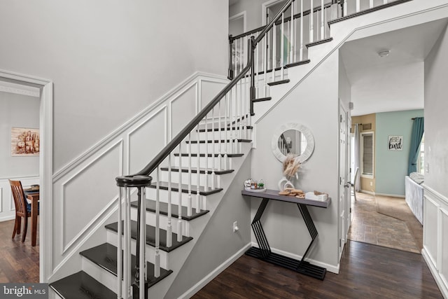 stairs featuring hardwood / wood-style floors