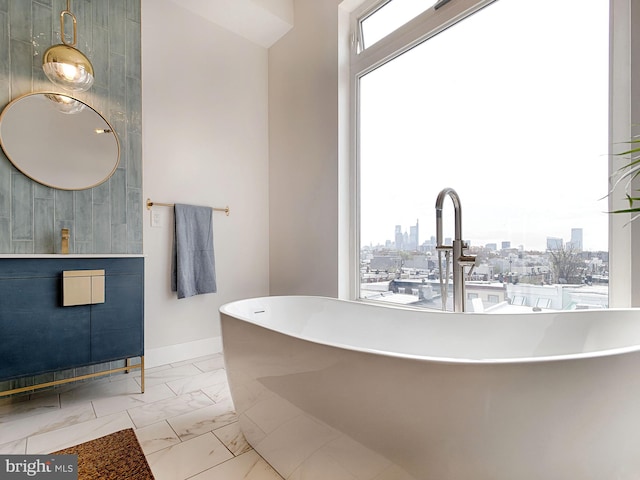 bathroom featuring a tub to relax in and a healthy amount of sunlight