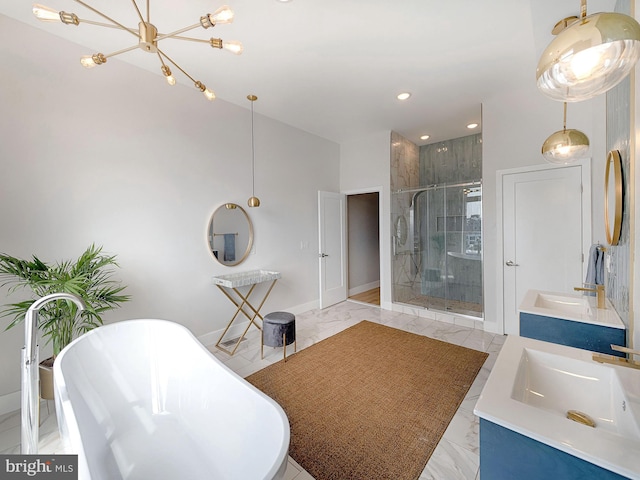 bathroom with plus walk in shower, an inviting chandelier, and vanity