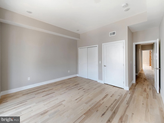 unfurnished bedroom with light wood-type flooring