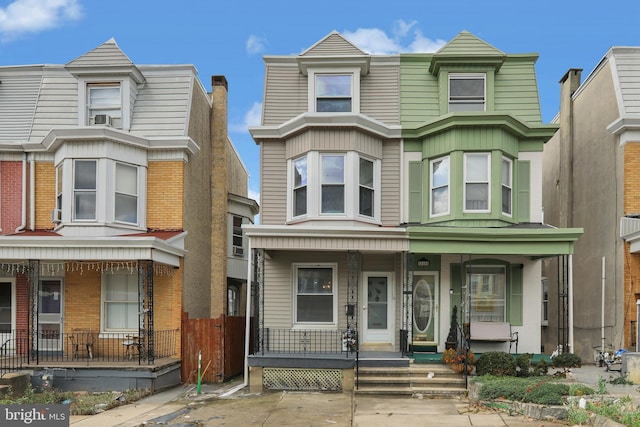 townhome / multi-family property with covered porch