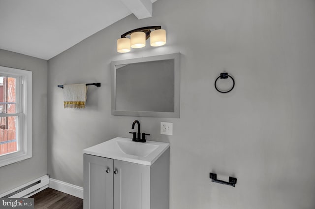 bathroom featuring vaulted ceiling with beams, hardwood / wood-style flooring, vanity, and a baseboard radiator