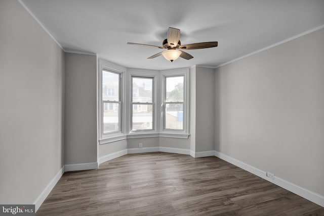 spare room with ornamental molding, hardwood / wood-style floors, and ceiling fan