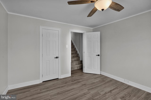 unfurnished bedroom with ornamental molding, ceiling fan, and hardwood / wood-style floors