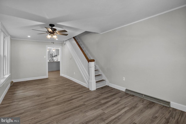 interior space with ceiling fan, dark hardwood / wood-style floors, and crown molding