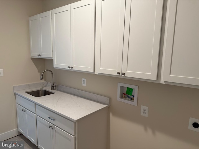 clothes washing area with cabinets, hookup for an electric dryer, sink, and washer hookup