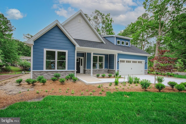 1 Tiller Ln, Ocean Pines, MD 21811 - view of front of home featuring stone siding, a garage, concrete driveway, a porch, and roof with shingles