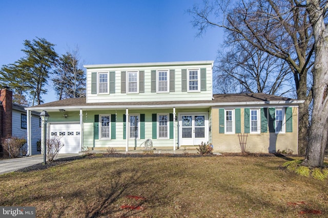 view of front facade featuring a garage and a front lawn