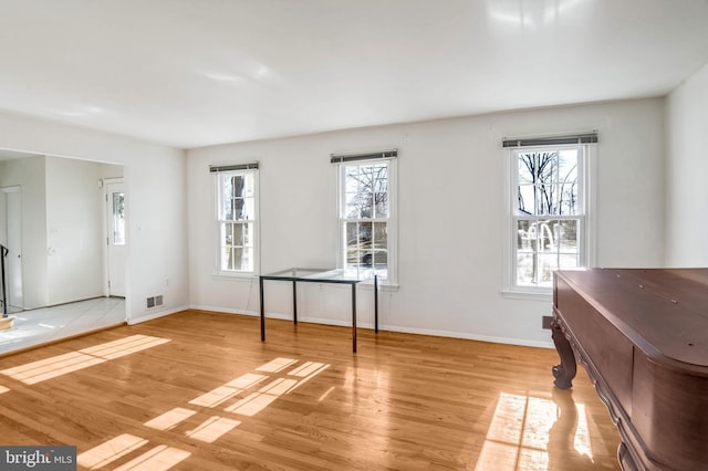 interior space with a wealth of natural light and light hardwood / wood-style flooring