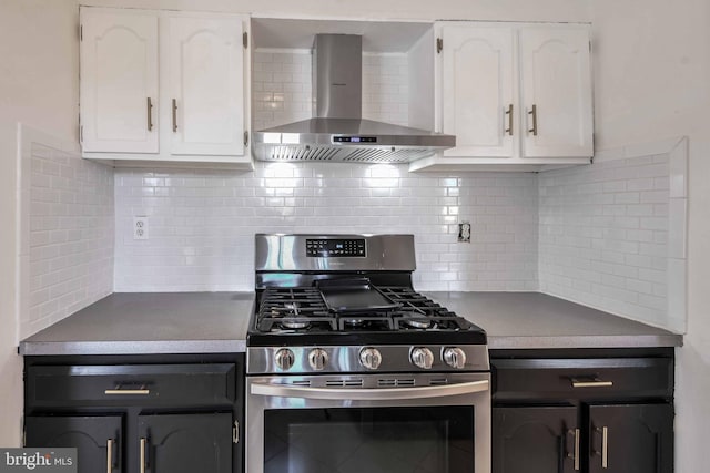 kitchen featuring white cabinetry, gas stove, tasteful backsplash, and wall chimney range hood