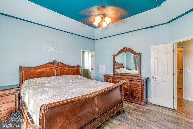 bedroom with light hardwood / wood-style floors and ceiling fan