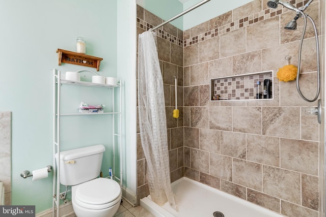 bathroom with tile patterned flooring, curtained shower, and toilet