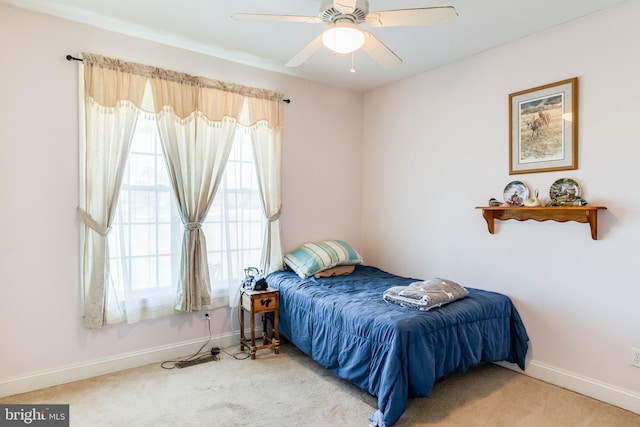 bedroom featuring ceiling fan and carpet