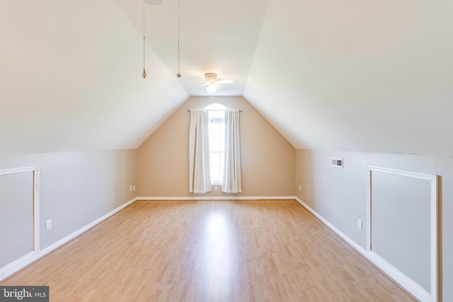 additional living space featuring lofted ceiling and light hardwood / wood-style floors