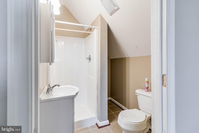 bathroom featuring tile patterned flooring, a shower, vanity, and toilet