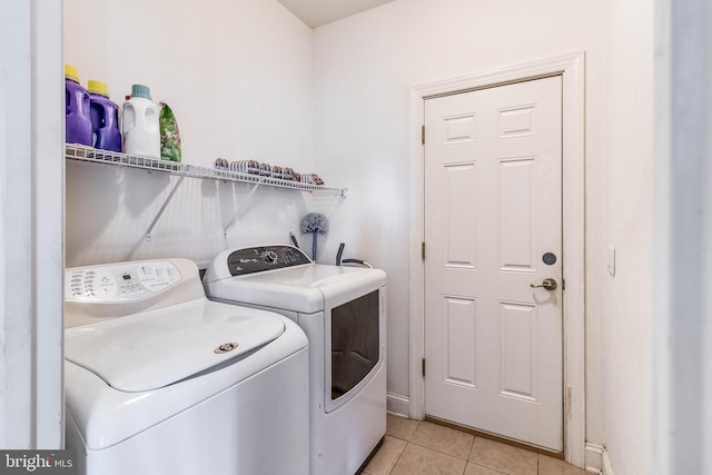 laundry room featuring washer and dryer and light tile patterned floors