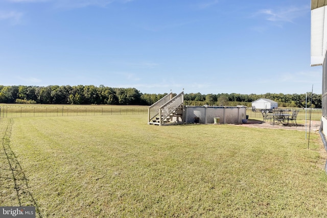 view of yard with a rural view