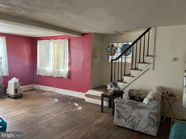 interior space featuring plenty of natural light, wood-type flooring, and a textured ceiling