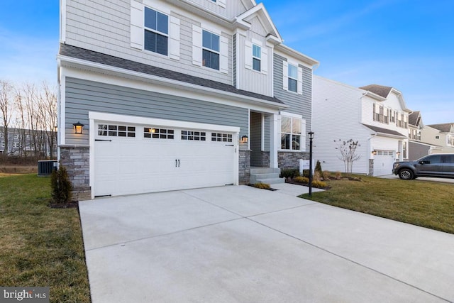 view of front of house with central AC unit, a garage, and a front lawn