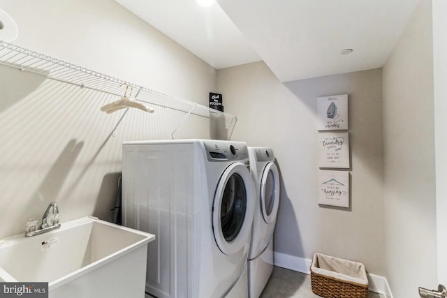 washroom with separate washer and dryer and sink