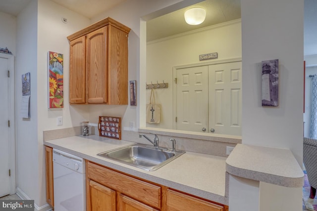 kitchen featuring crown molding, sink, light brown cabinets, and dishwasher