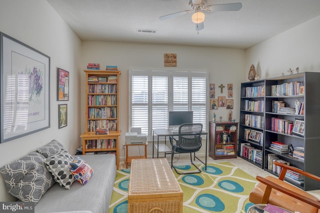 living area with light carpet and ceiling fan