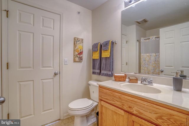 bathroom featuring vanity, tile patterned floors, toilet, and curtained shower