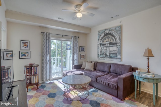 living room featuring hardwood / wood-style flooring and ceiling fan