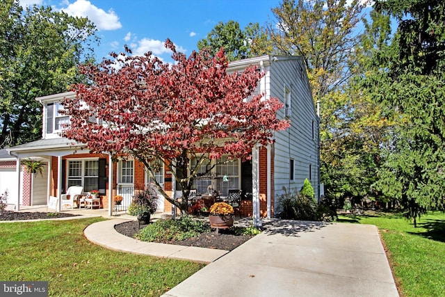 view of front of house featuring a front lawn and covered porch