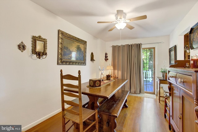 dining area with wood-type flooring and ceiling fan