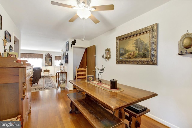 dining area featuring ceiling fan and wood-type flooring