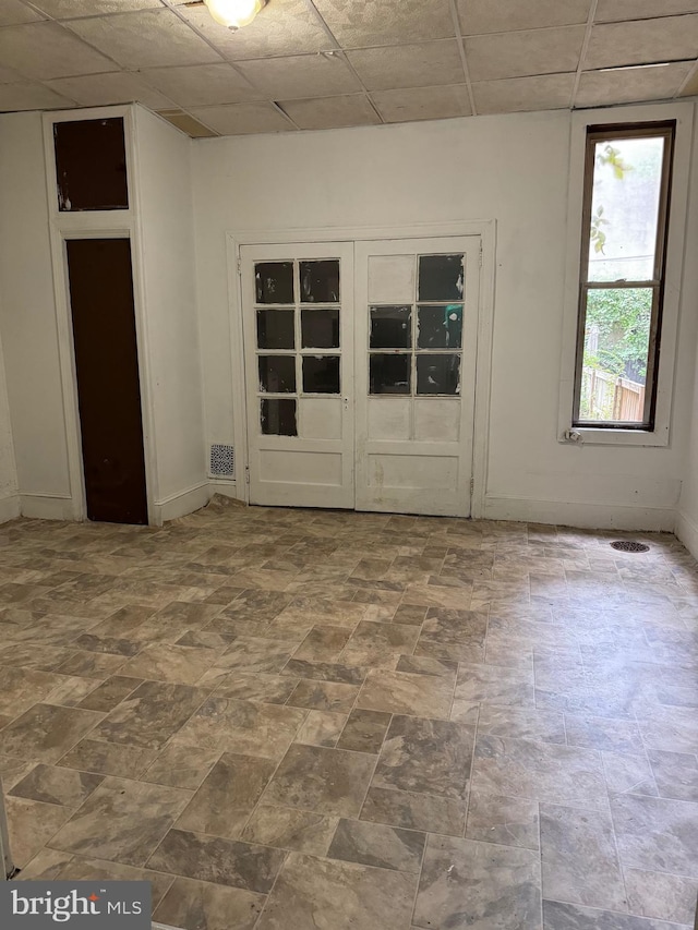 empty room featuring a paneled ceiling