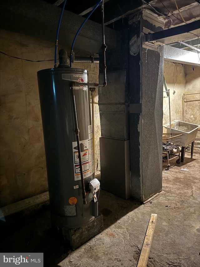 utility room featuring gas water heater and heating unit