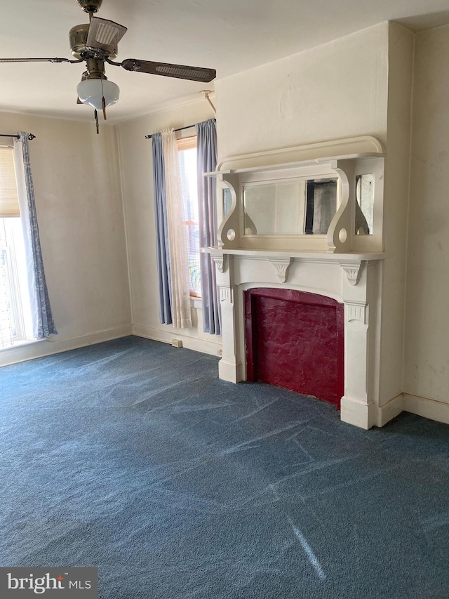 unfurnished living room with carpet and ceiling fan