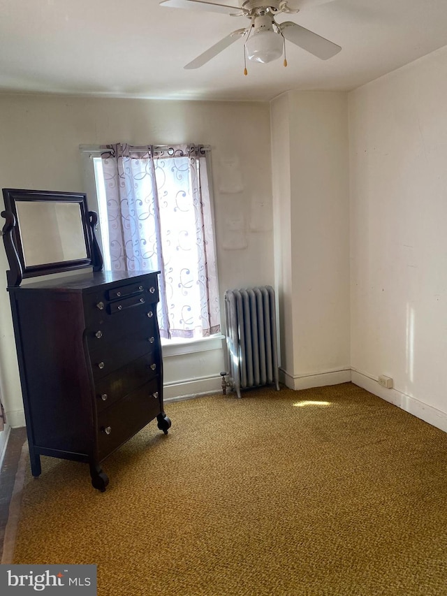 interior space with radiator, carpet, and ceiling fan